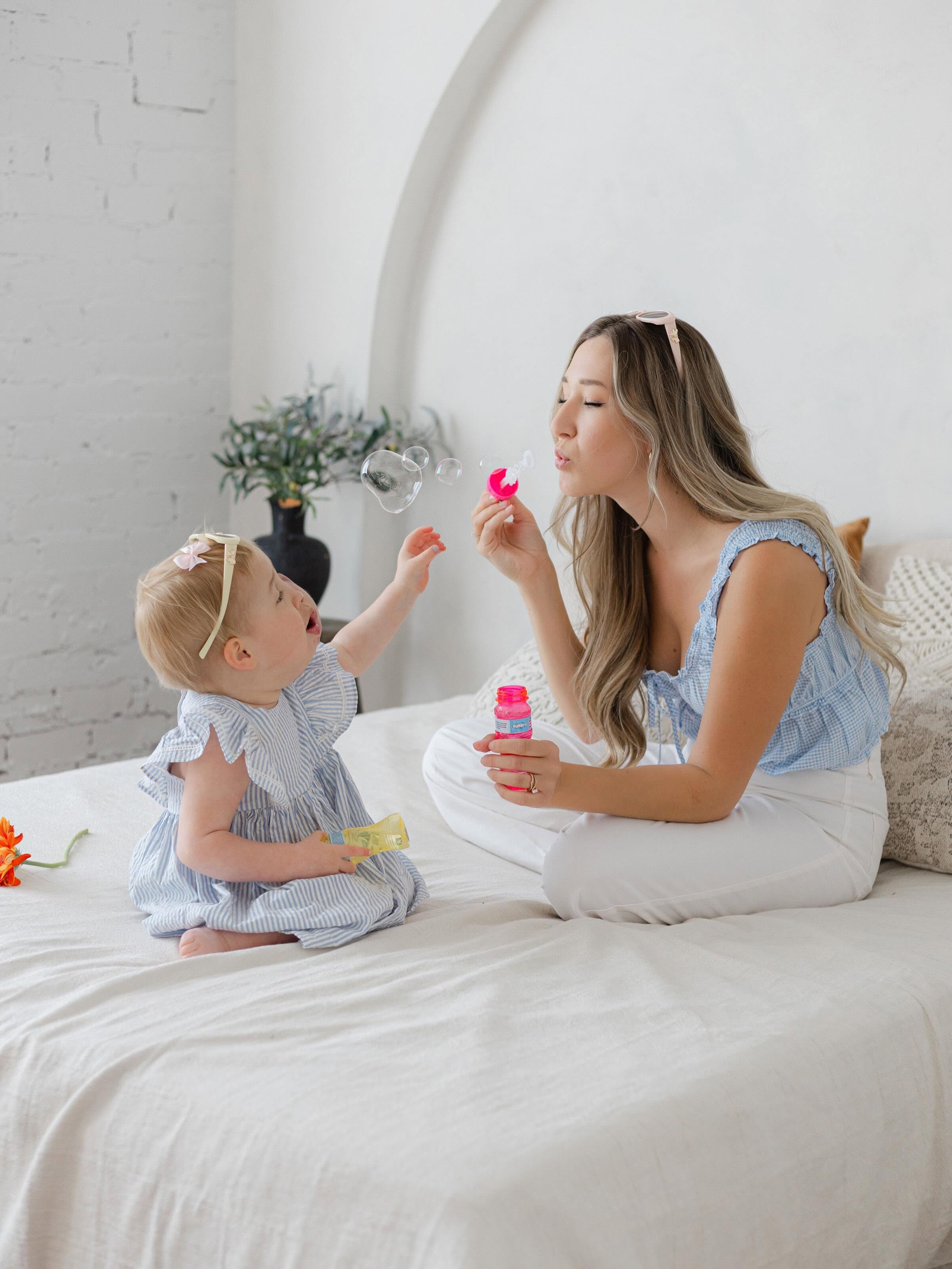 Myla and her mother playing with bubbles together